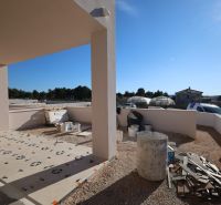 Construction work on the terrace of a holiday apartment in Vodice, sunny day, visible containers and materials.