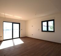 Interior of a vacation apartment with large windows and a wooden decor floor.