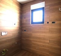 Recreational apartment with wood decor tiles and a small window.