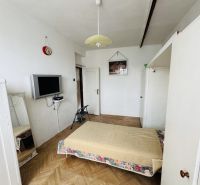 A bedroom with a mattress, a television, and a wooden decor floor in a 3-room apartment.