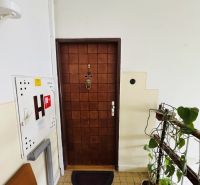 Entrance door of a three-room apartment number nine, leading to the staircase.