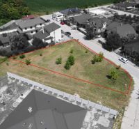 Plots - residential area in Zálesie on Cintorínska Street with young trees and grassy area.