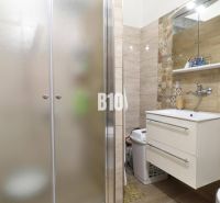 Bathroom in a family house with a sink and a shower.