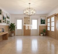 Interior of a family house with wooden decor, a mirror, paintings, and plants.