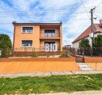 A family house in Lukáčovce with a garden and an elevated entrance surrounded by a fence.