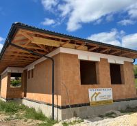 A family house under construction on Pánska Niva in Hlohovec, with a rough brick structure.