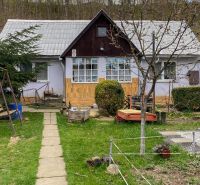 A family house on Levočská Street in Stará Ľubovňa, surrounded by a garden and a swinging bench.