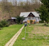 A family house on Levočská Street in Stará Ľubovňa surrounded by a garden and trees.