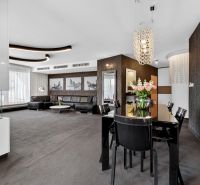 Living room with a sofa, dining table, and fireplace in a 4-room apartment.