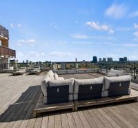 Rooftop terrace in Bratislava - Ružinov on Jégého with a view of the city and seating.