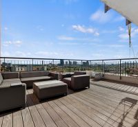 Terrace with seating and a view of the city in Bratislava on Jégého in a 4-room apartment.