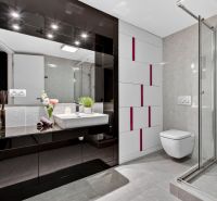 Bathroom in a 4-room apartment with glossy tiles, a shower corner, and a sink.