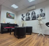 Interior of commercial spaces with wood-patterned flooring and artistic photographs.