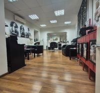 Interior of commercial spaces with wood-patterned flooring and interior furniture.