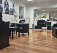 Commercial space with armchairs and wooden decor flooring, comfortable seating.