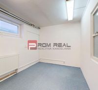 A room with white walls, a blue carpet, and windows. Warehouses and halls.