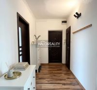 Interior of a 3-room apartment with wood-patterned flooring and modern furniture.