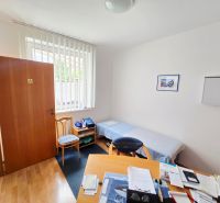 A cozy room in a two-room apartment with a wooden decor floor.