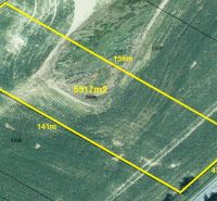 Aerial view of residential land in the village of Svinná with a road on Svinná Street.