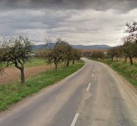 A tree-lined path leads through the Lands - housing near Svinná, Svinná, with a view of the fields.