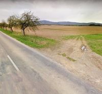 A road in Svinná surrounded by fields and trees, ideal for plots - housing.