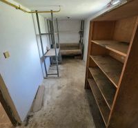 Storage room in a family house with a basic shelf and shelves.
