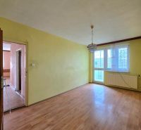 A room with a wooden floor decor, a chandelier, and a window in a family house.