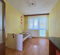 A room in a family house with a bed, a drawing on the wall, and a floor with a wooden decor.