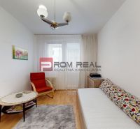 A room with a wooden floor decor, a sofa, and an armchair in a 3-room apartment.