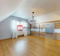 A room with a wooden decor floor and a built-in wardrobe in a family house.