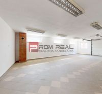 A spacious garage in a family house with white walls and panel lighting.