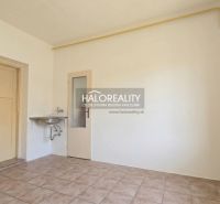 Empty room with a sink and tiles in a family house.