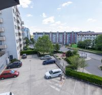 View from a 2-room apartment on Kadnárova Street in Bratislava - Rača with a parking lot.