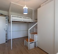 A children's room with a bunk bed and a wooden decor floor in a 2-room apartment.