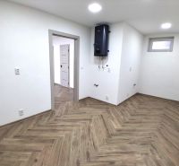 Commercial premises with wood-patterned flooring and a wall-mounted boiler.