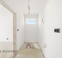 An empty room with white walls and preparation for underfloor heating in a family house.