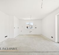 A spacious unfurnished interior room in a family house with a view of the exterior.