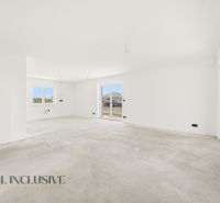 Spacious room with white walls and an empty floor, living area of a family house.