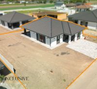 A family house in Hviezdoslavov with a sloped roof and an untended garden.