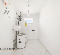 Utility room with white walls and a boiler in a family house.