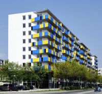 Apartment building on Tomášikova Street, Bratislava - Ružinov, with colorful balconies and parked cars.
