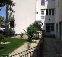 Entrance to the apartment building with a landscaped front garden on Vajnorská Street, Bratislava - Nové Mesto.