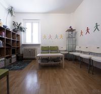 Children's room in a 3-room apartment with a wooden decor floor, colorful wall decorations.
