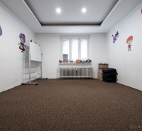 Children's room in a 3-room apartment with decorations and a carpet, a board on wheels.