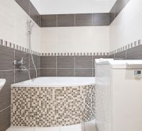 A bathroom in a 3-room apartment with a bathtub, sink, and washing machine.