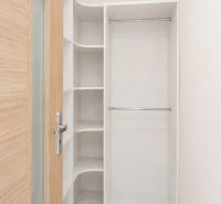 Storage space with shelves and a hanging rod in a 3-room apartment.