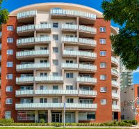 Apartment building on Bosákova Street in Bratislava - Petržalka with balconies and trees.