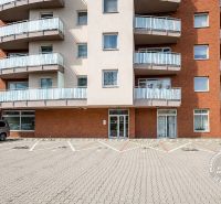 The exterior of an apartment building with balconies on Bosákova Street, Bratislava - Petržalka, in front of the garages.