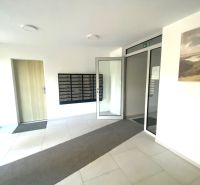 The interior of offices with mailboxes and glass doors.