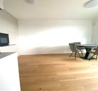 Offices with wood-patterned flooring, white walls, a round table, and four chairs.